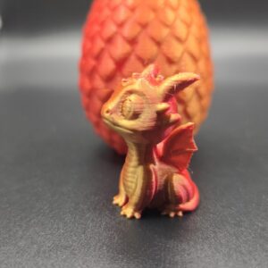 Draakje en ei oranje rood